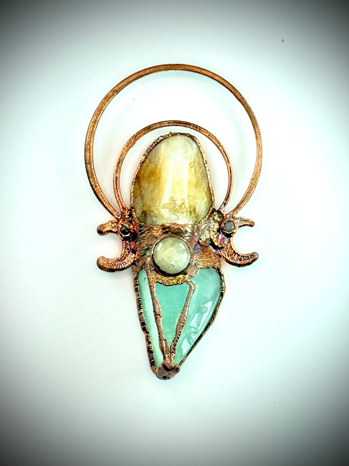 Handmade copper pendant with carnelian, green calcite, yellow jade cabochon, and crescent moons – crystal jewellery for confidence and heart healing.