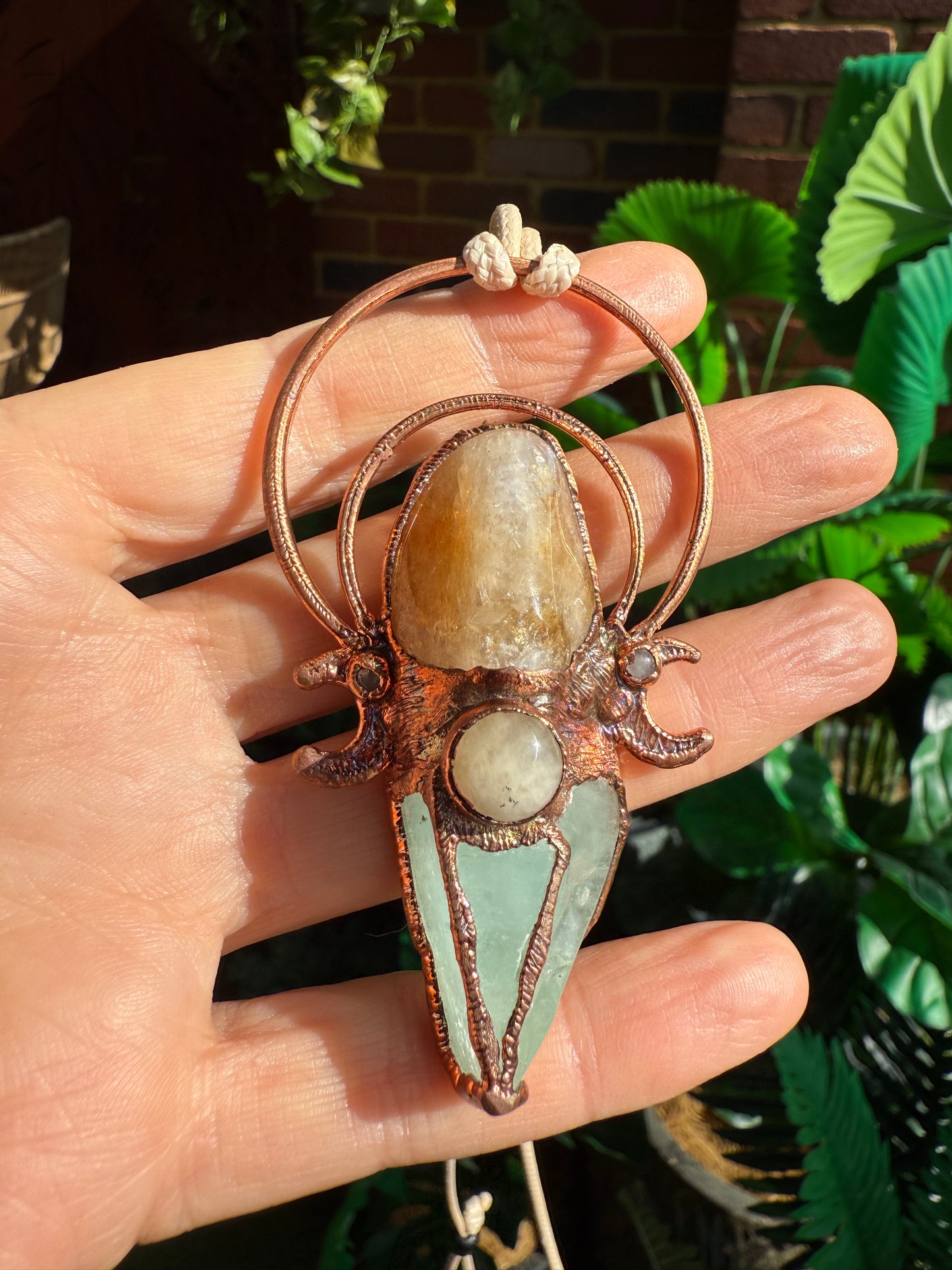 Crystal pendant featuring carnelian, green calcite, and yellow jade with copper moons – handmade boho jewellery