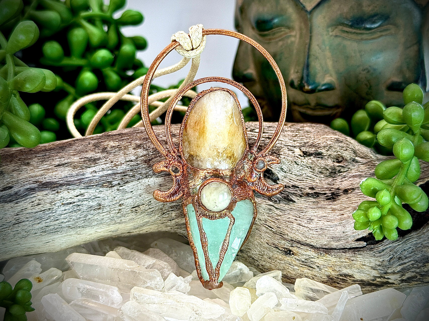 Handmade copper pendant with carnelian, green calcite, yellow jade cabochon, and crescent moons – crystal jewellery for confidence and heart healing.