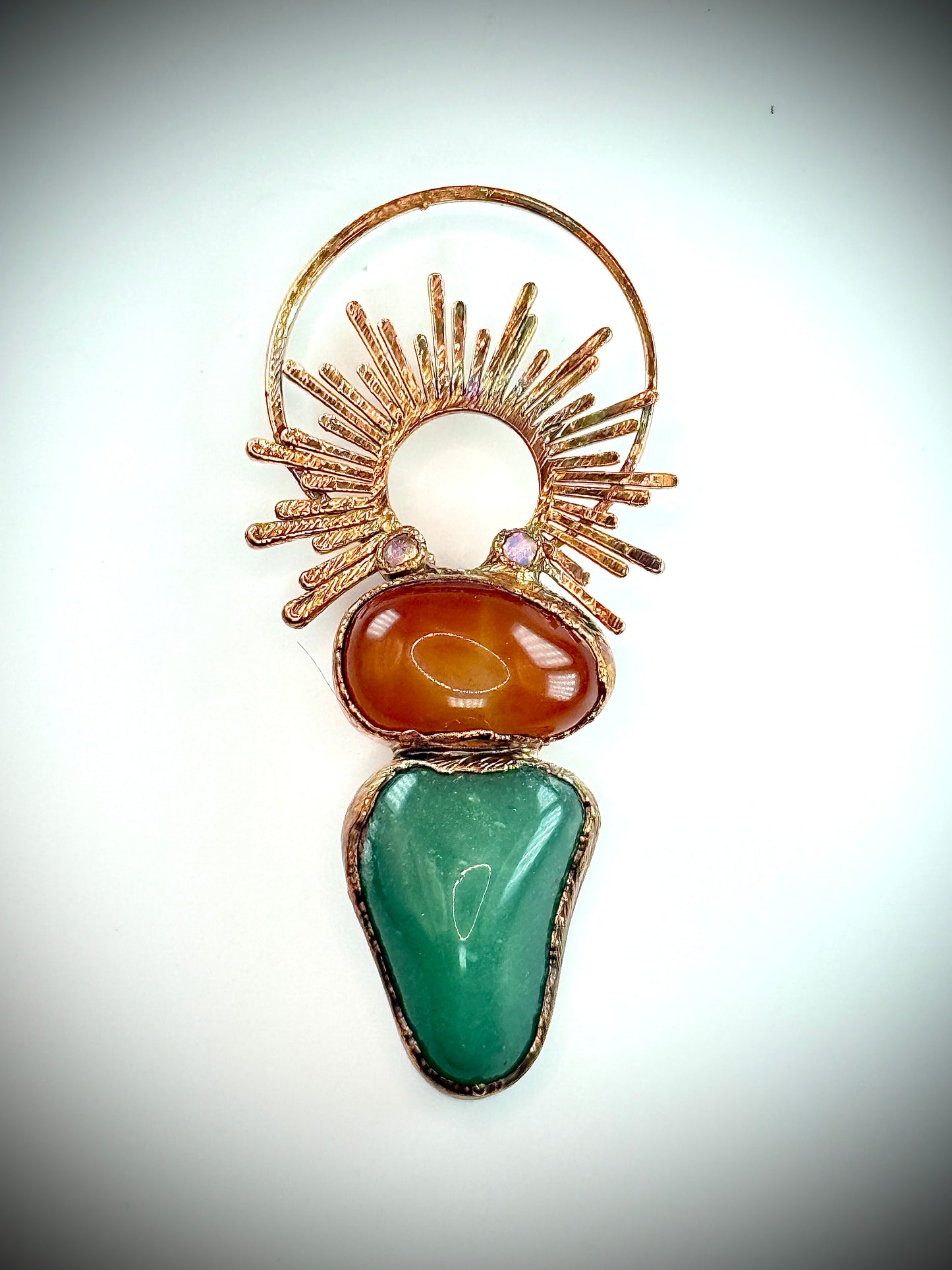Handmade copper pendant with carnelian, green fluorite, moonstone accents, and sunburst detail – crystal jewellery for emotional balance and intuitive power.