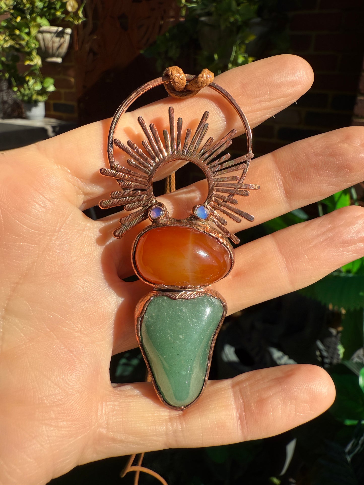 Handmade copper pendant with carnelian, green fluorite, moonstone accents, and sunburst detail – crystal jewellery for emotional balance and intuitive power.