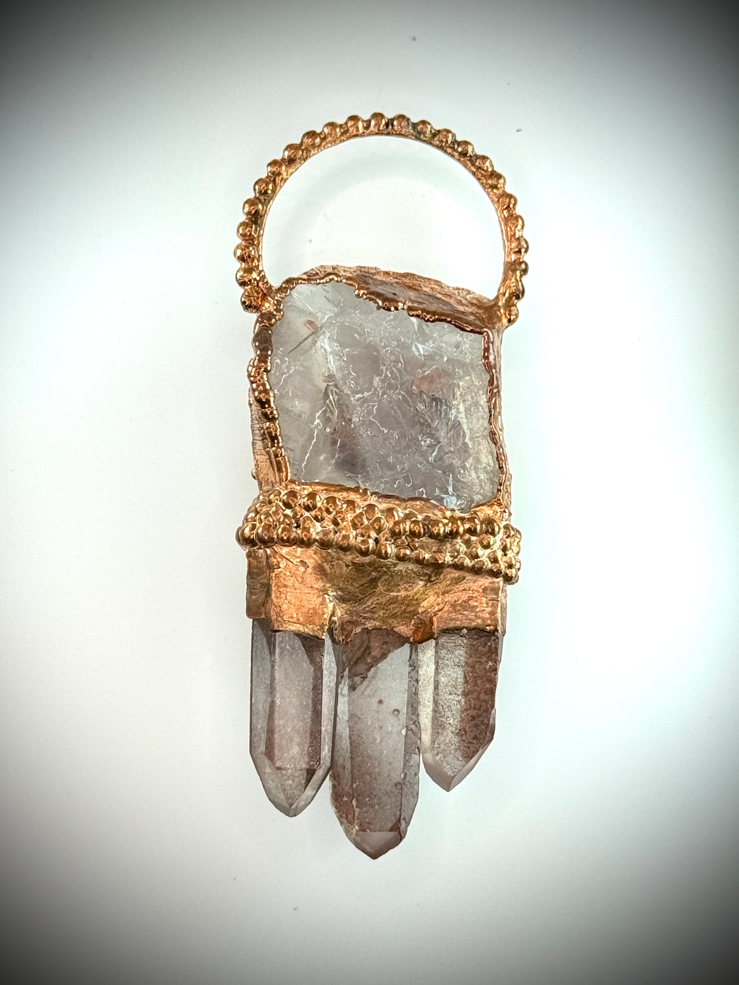 Handmade copper pendant with clear quartz crown, red lithium quartz points, carnelian cabochon, and sunburst accent – fiery crystal statement jewellery.