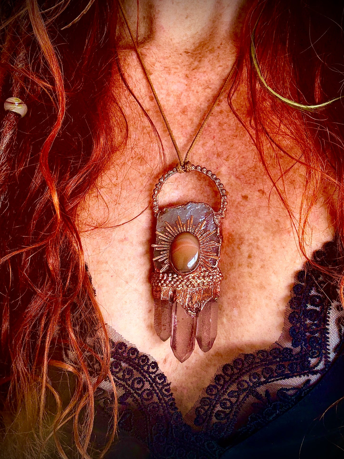 Handmade copper pendant with clear quartz crown, red lithium quartz points, carnelian cabochon, and sunburst accent – fiery crystal statement jewellery.