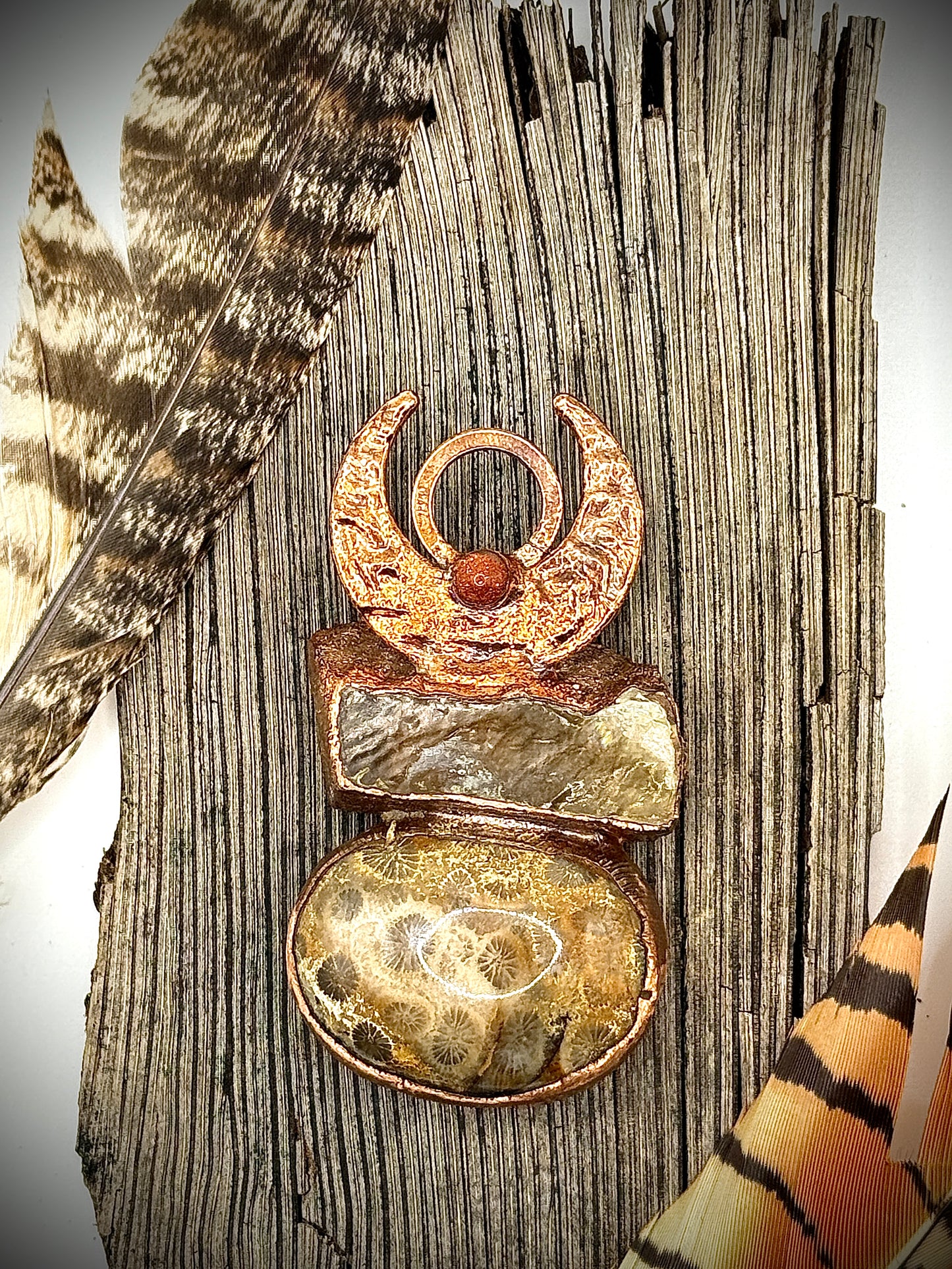 Handmade copper pendant with honey calcite, fossilized coral, goldstone, and an inverted crescent moon – earthy crystal jewellery for ambition and wisdom.