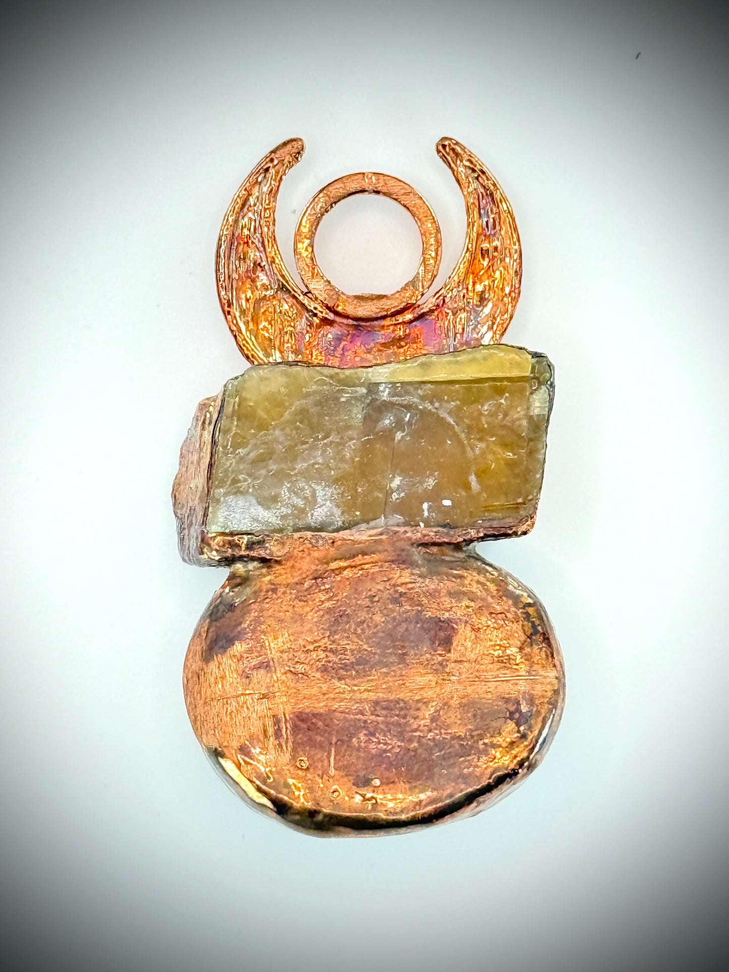 Handmade copper pendant with honey calcite, fossilized coral, goldstone, and an inverted crescent moon – earthy crystal jewellery for ambition and wisdom.
