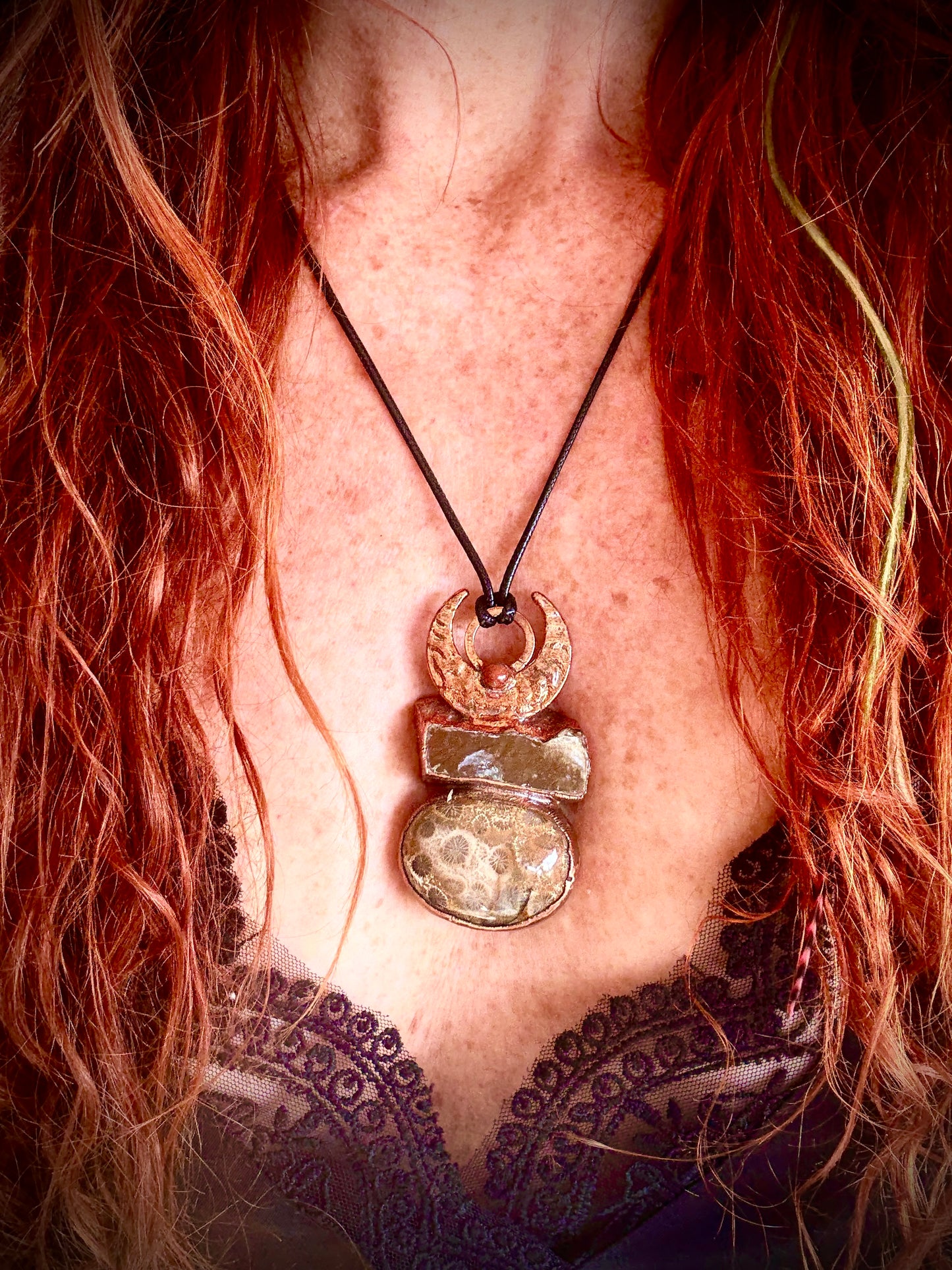 Handmade copper pendant with honey calcite, fossilized coral, goldstone, and an inverted crescent moon – earthy crystal jewellery for ambition and wisdom.