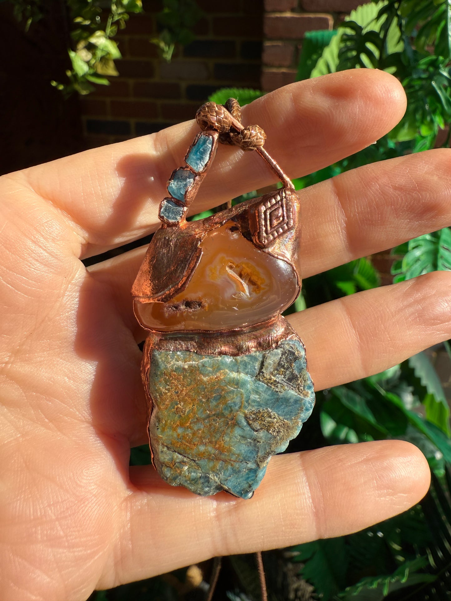 Handmade copper pendant with raw blue apatite, carnelian, and triangular top – funky crystal jewellery for creative expression and throat chakra alignment.