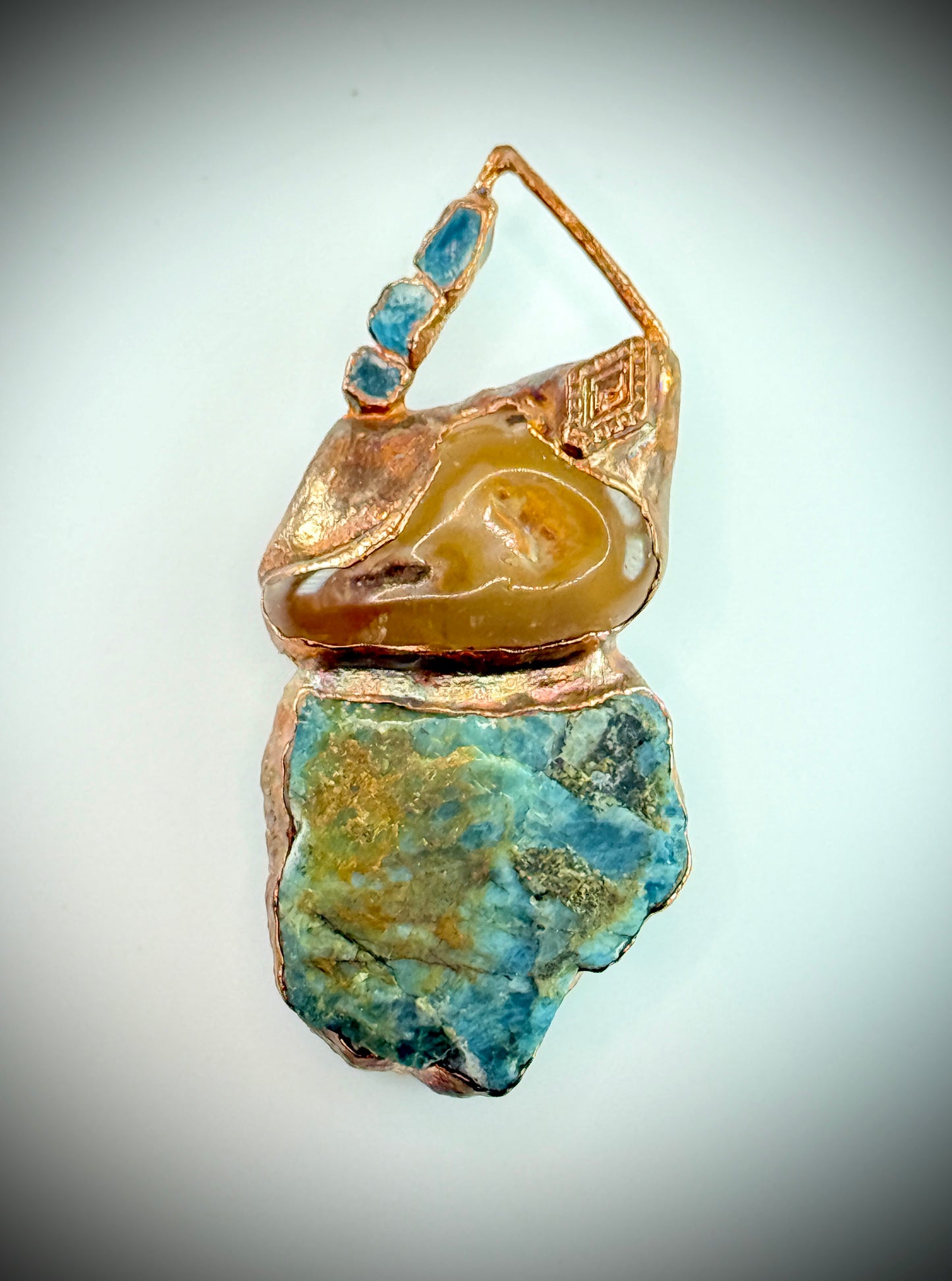 Handmade copper pendant with raw blue apatite, carnelian, and triangular top – funky crystal jewellery for creative expression and throat chakra alignment.