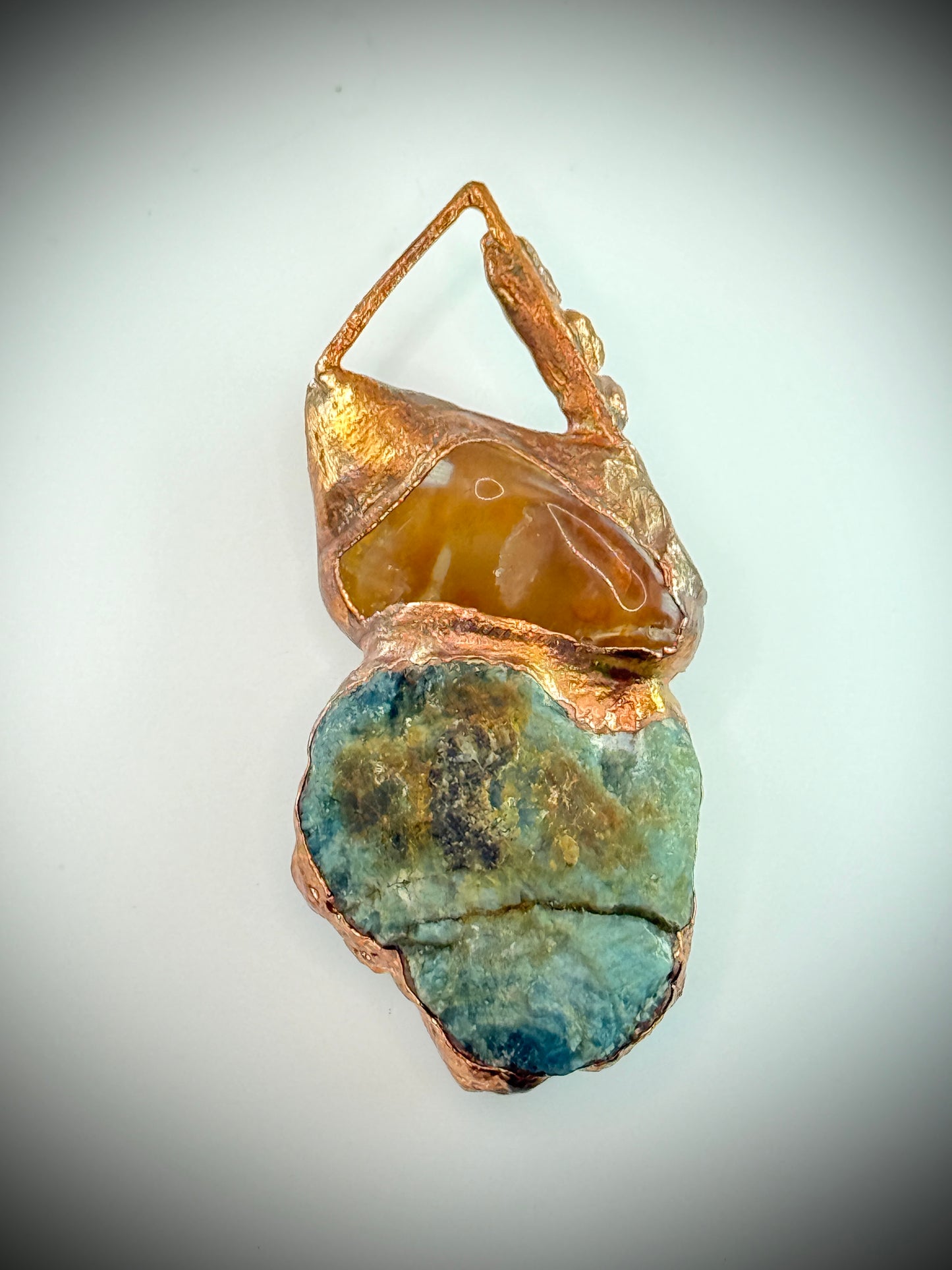 Handmade copper pendant with raw blue apatite, carnelian, and triangular top – funky crystal jewellery for creative expression and throat chakra alignment.
