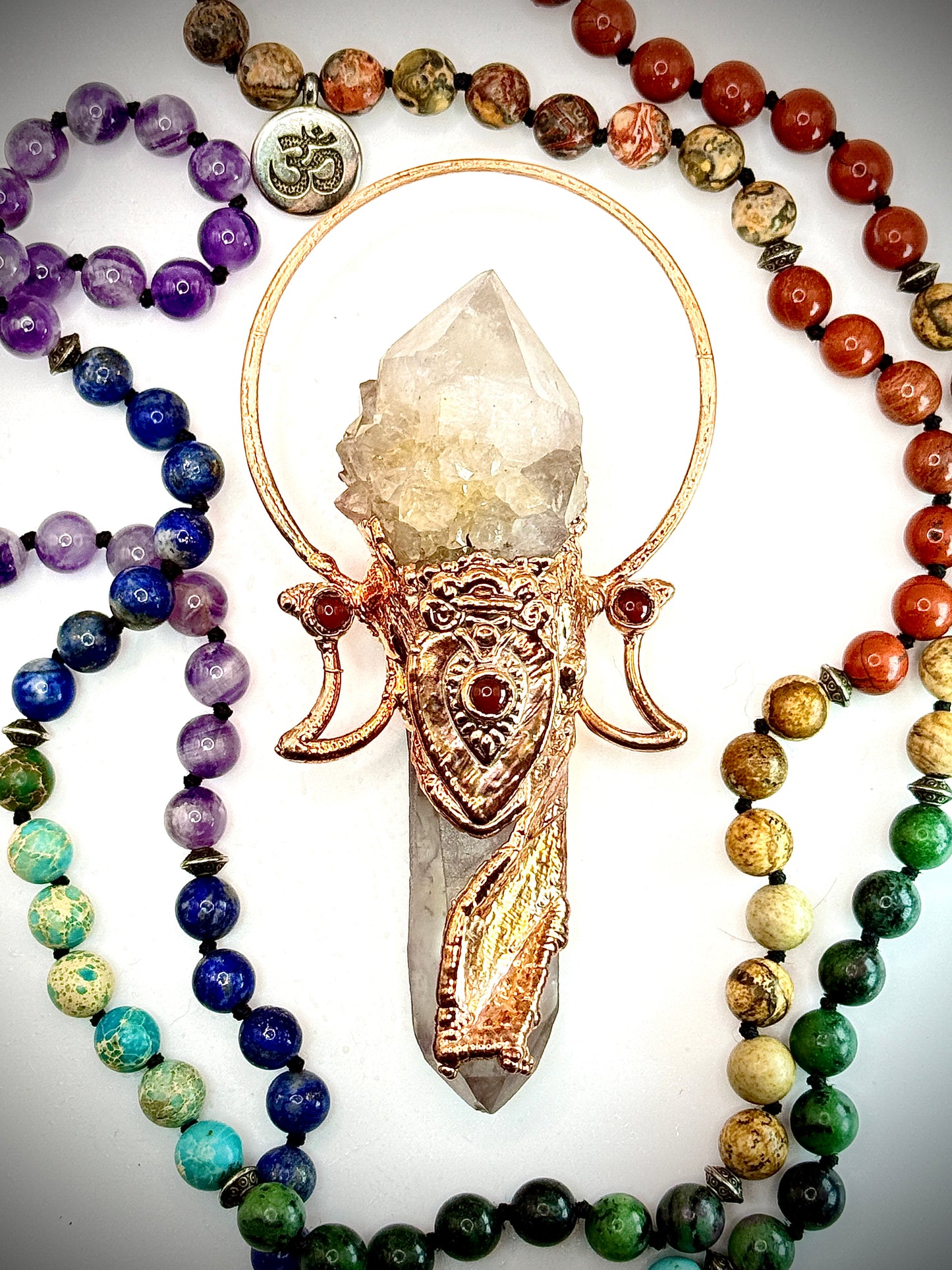 Goddess-inspired pendant with smoky quartz and clear quartz point bearing a crystal growth imprint – accented with copper and carnelian.