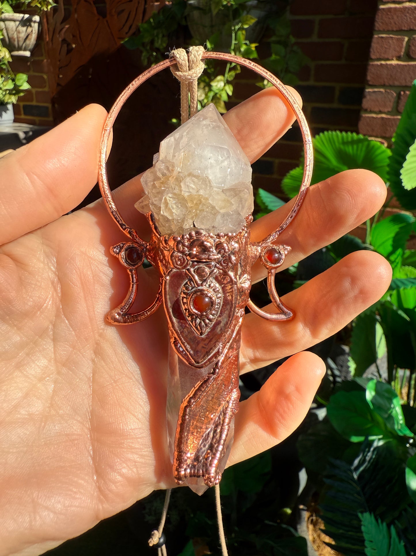 Goddess-inspired pendant with smoky quartz and clear quartz point bearing a crystal growth imprint – accented with copper and carnelian.