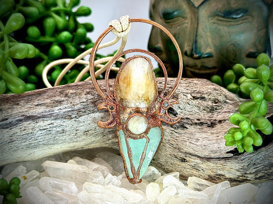Handmade copper pendant with carnelian, green calcite, yellow jade cabochon, and crescent moons – crystal jewellery for confidence and heart healing.