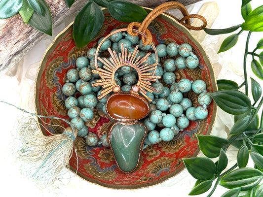 Handmade copper pendant with carnelian, green fluorite, moonstone accents, and sunburst detail – crystal jewellery for emotional balance and intuitive power.