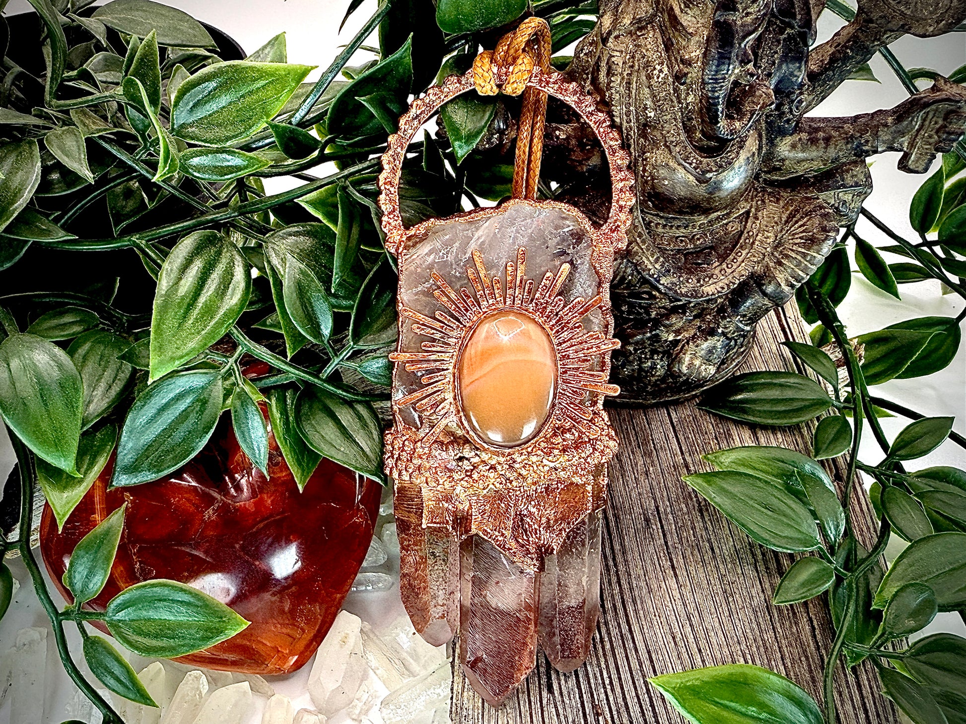 Handmade copper pendant with clear quartz crown, red lithium quartz points, carnelian cabochon, and sunburst accent – fiery crystal statement jewellery.
