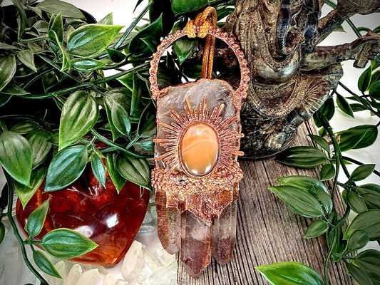Handmade copper pendant with clear quartz crown, red lithium quartz points, carnelian cabochon, and sunburst accent – fiery crystal statement jewellery.