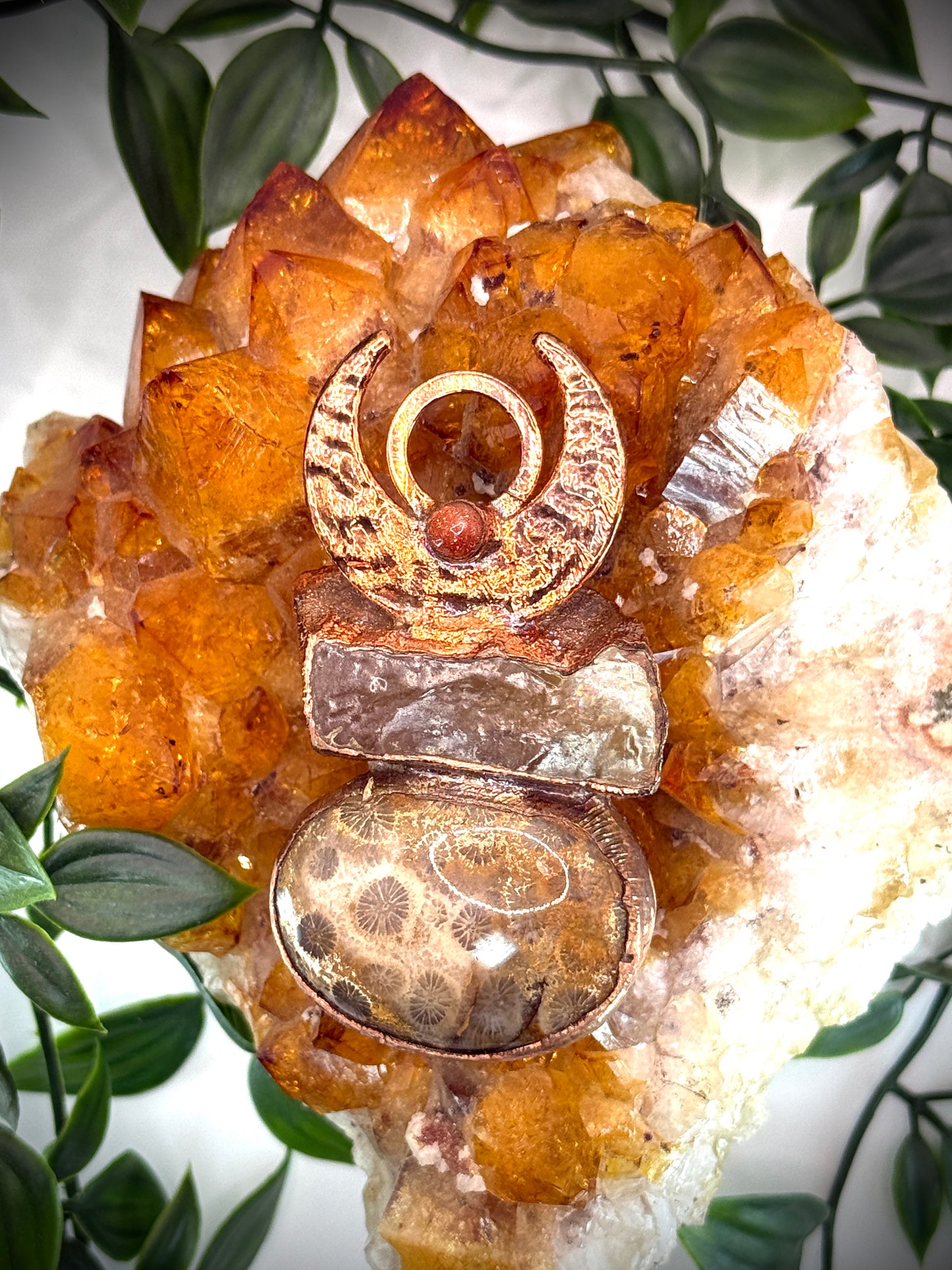 Handmade copper pendant with honey calcite, fossilized coral, goldstone, and an inverted crescent moon – earthy crystal jewellery for ambition and wisdom.