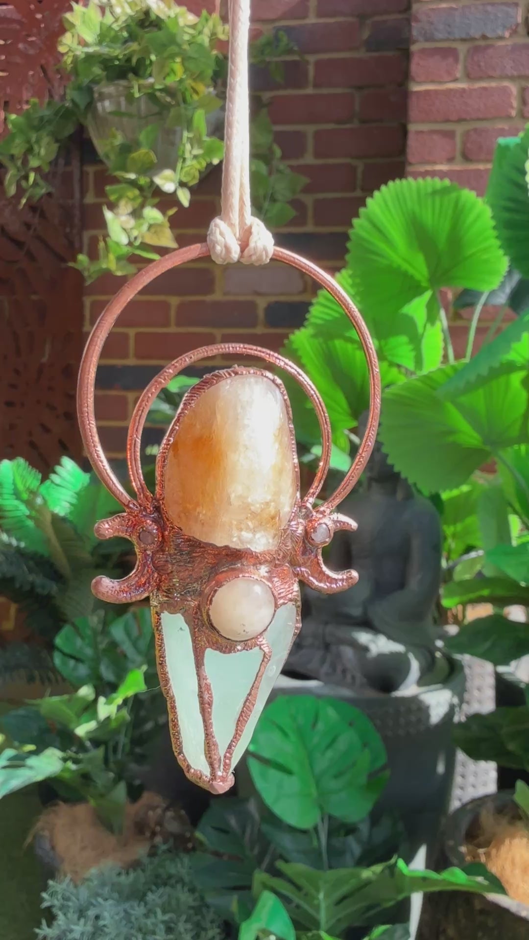 Handmade copper pendant with carnelian, green calcite, yellow jade cabochon, and crescent moons – crystal jewellery for confidence and heart healing.