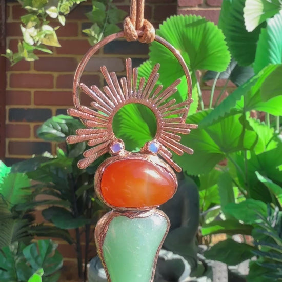 Handmade copper pendant with carnelian, green fluorite, moonstone accents, and sunburst detail – crystal jewellery for emotional balance and intuitive power.