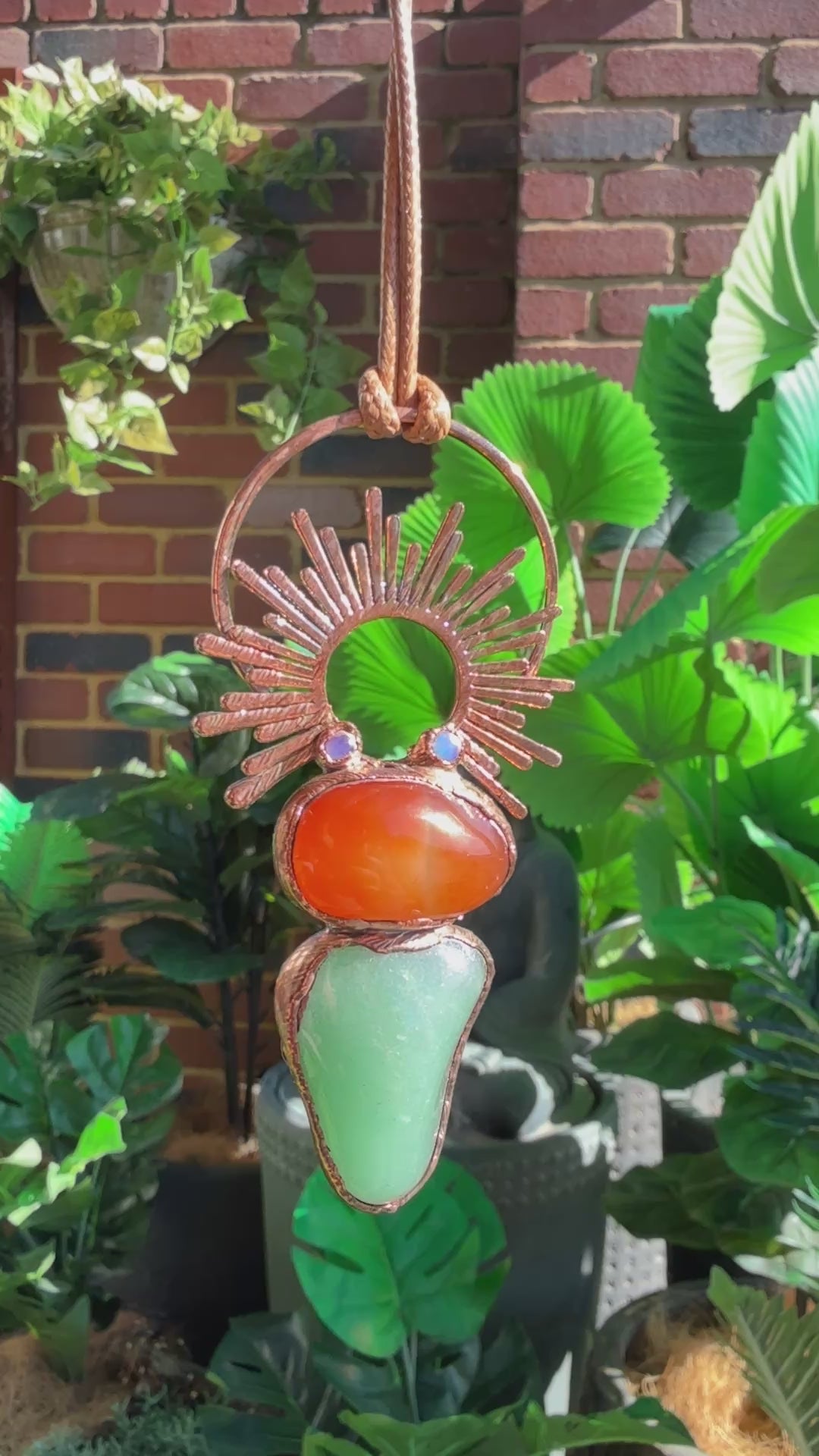 Handmade copper pendant with carnelian, green fluorite, moonstone accents, and sunburst detail – crystal jewellery for emotional balance and intuitive power.