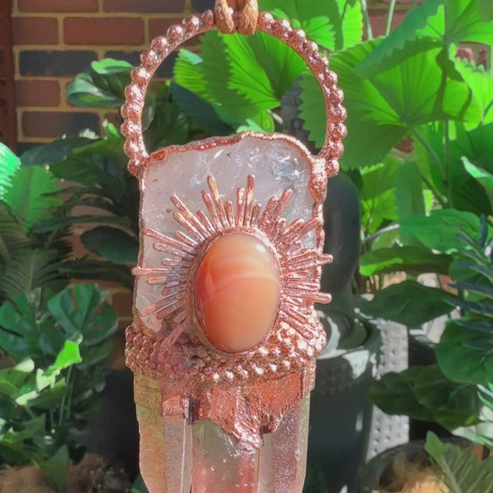 Handmade copper pendant with clear quartz crown, red lithium quartz points, carnelian cabochon, and sunburst accent – fiery crystal statement jewellery.