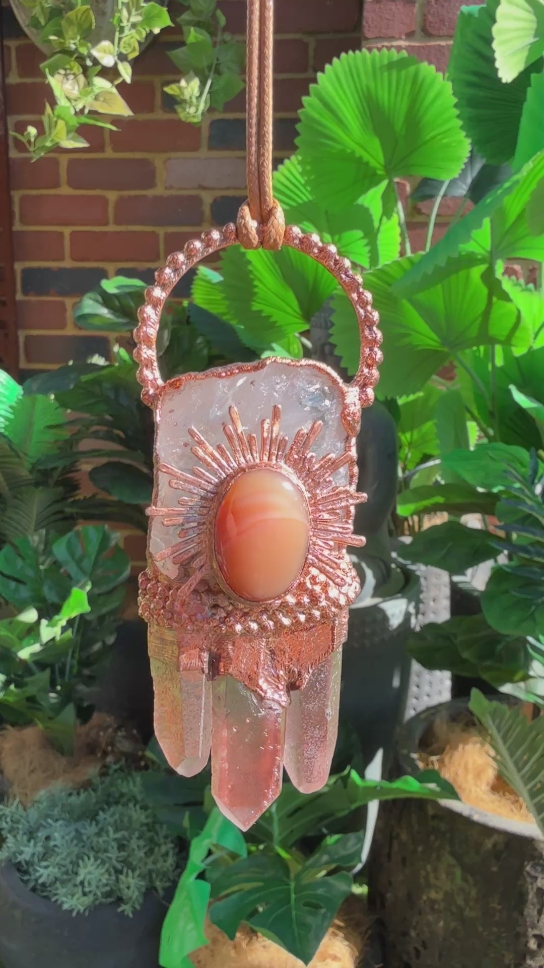 Handmade copper pendant with clear quartz crown, red lithium quartz points, carnelian cabochon, and sunburst accent – fiery crystal statement jewellery.