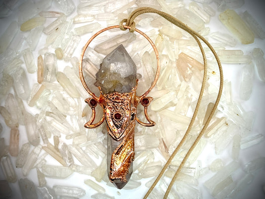Goddess-inspired pendant with smoky quartz and clear quartz point bearing a crystal growth imprint – accented with copper and carnelian.