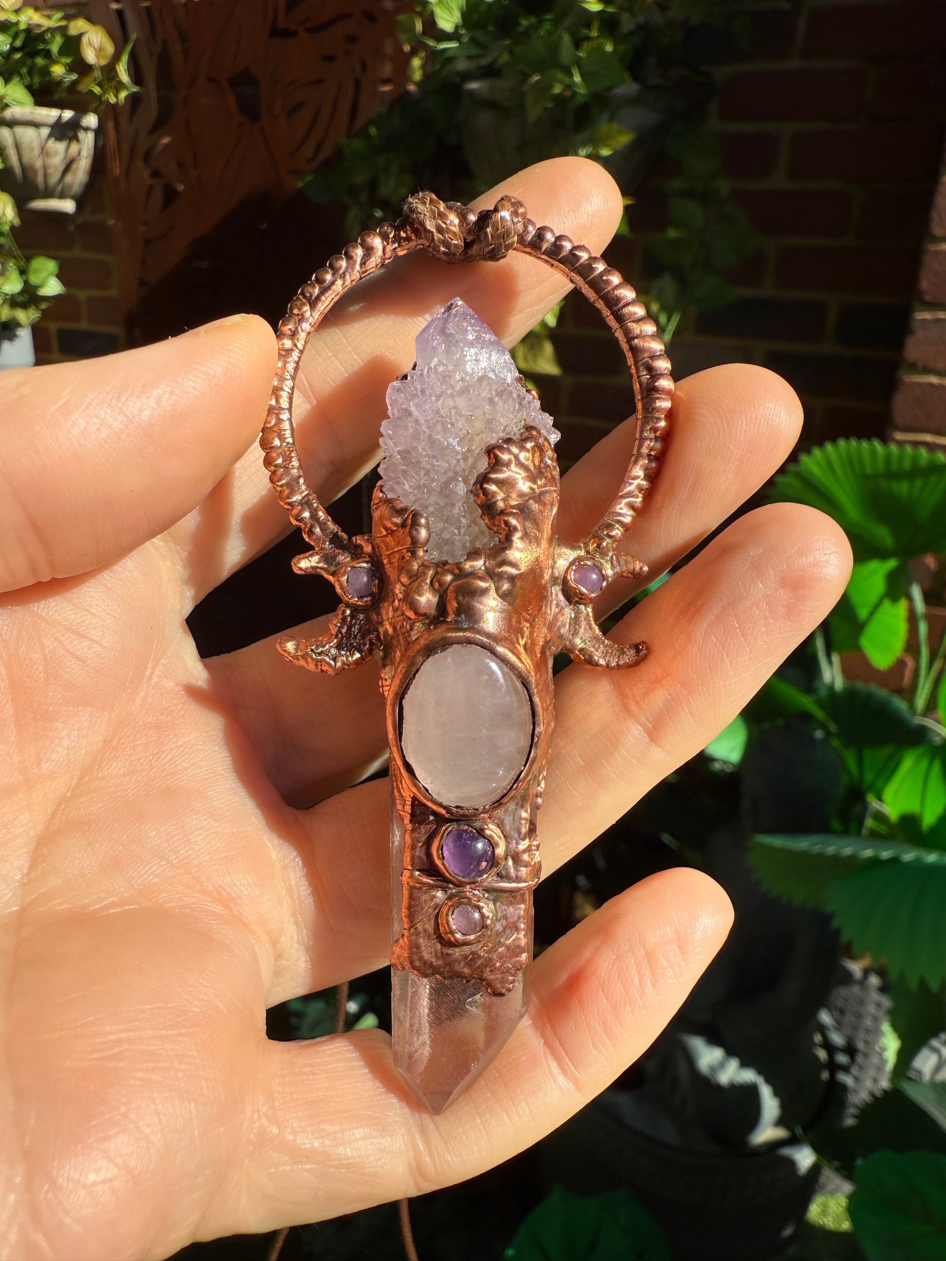 Handmade copper pendant with spirit quartz, red lithium quartz, rose quartz, amethyst, and crescent moons – crystal jewellery for love and divine connection.